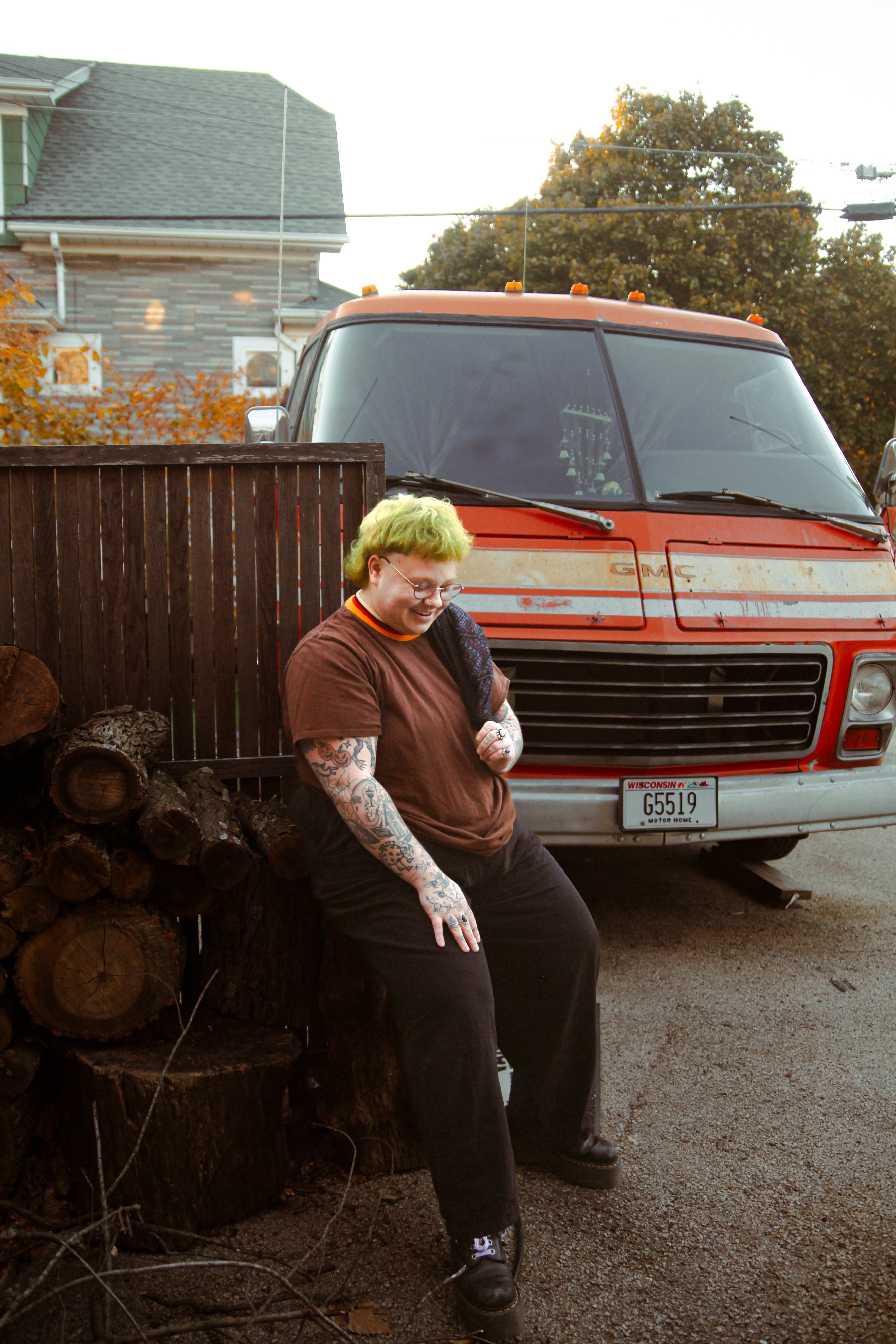 person with green hair by orange van